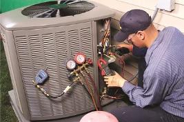 a technician working on an outdoor unit
